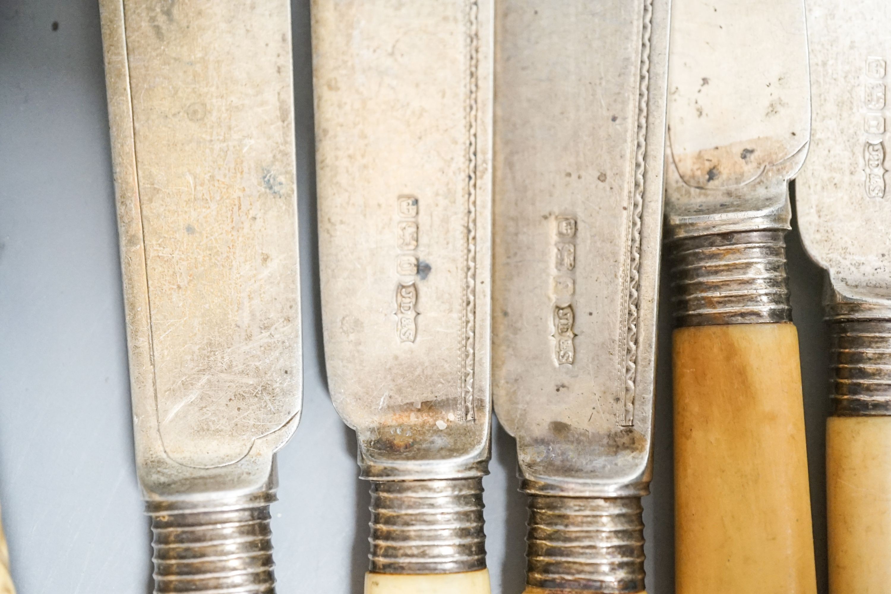 Eight ivory handled silver fish knives and three forks and a pair of plated servers.